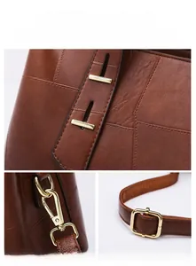 Detail of polished gold hardware and fine leather texture on brown tote handbag