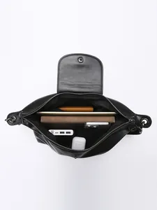 Large capacity black soft leather tote bag showing organized interior with electronics