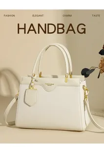Detailed macro view of the cream lychee grain leather texture and elegant gold hardware