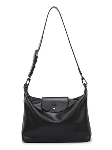 Minimalist black soft leather tote bag with metallic logo and adjustable strap for commuting