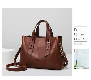 Detail view of dark brown leather handbag with geometric stitching and gold hardware