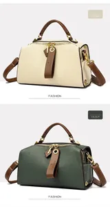Dettaglio borsa Boston crema e grigio verde con trama litchi e finiture dorate