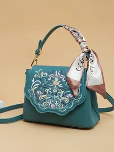 Vintage teal crossbody bag with floral embroidery and silk scarf wrapped handle