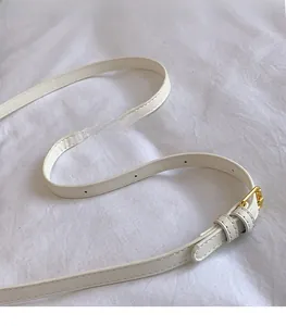 Adjustable white faux leather shoulder strap with gold buckle and fine stitching detail