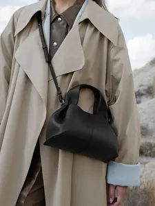 Detail of black cloud bag featuring lychee texture leather and adjustable shoulder strap