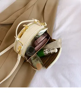 Internal view of white round crossbody bag showing spacious storage for cosmetics