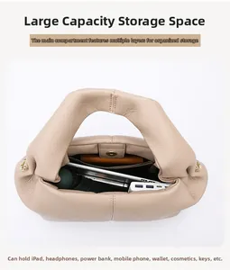 Interior view of beige cloud handbag showing multi-layer compartments and large capacity