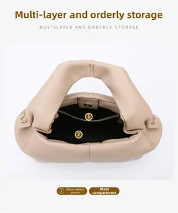 Interior view of beige leather cloud bag showing main compartment and zipper pocket