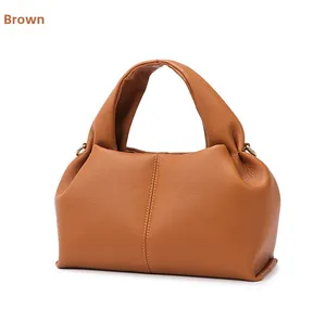Detail view of brown cloud tote bag showing pebble grain leather and soft pleated design