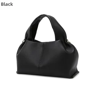 Close-up of black cloud handbag featuring premium lychee texture and pleated leather detail