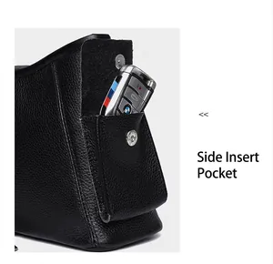 Detail view of side pocket with magnetic silver buckle on black lychee leather handbag