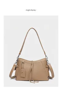 Detail view of genuine leather shoulder bag with lychee texture and dual strap design