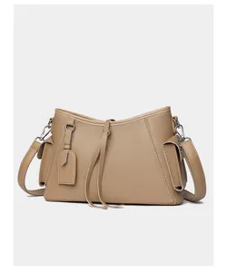 Detailed macro view of khaki lychee grain leather texture with side flap pocket and silver hardware