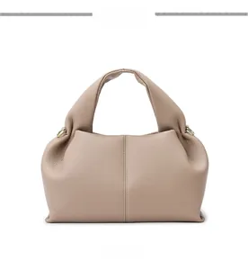 Front view of beige leather cloud bag showing vertical stitching and soft texture