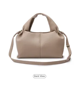 Detail view showing the smooth leather texture and back construction of this cloud bag