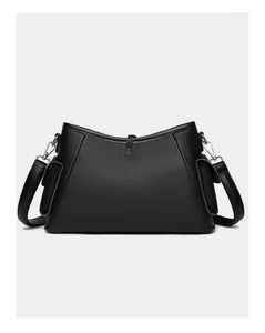 Close-up of black lychee grain leather shoulder bag with side pockets and silver hardware