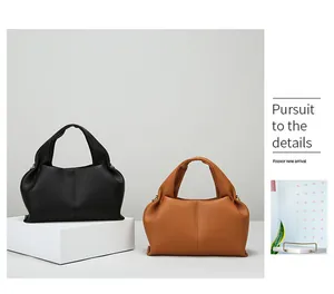 Detail showing high-quality lychee textured leather and stitching on the cloud handbag