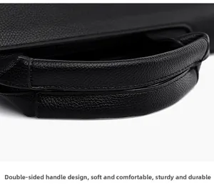 Detail of the double-sided handles and fine lychee grain leather on black handbag