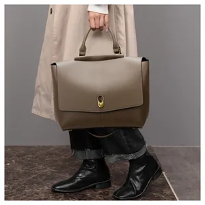 Detail of premium matte leather tote bag with gold lock and sleek shoulder strap