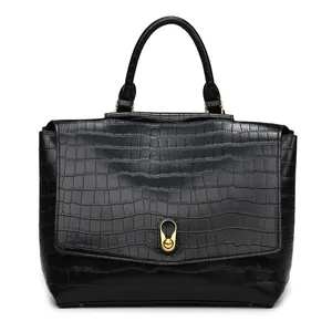 Close-up of black crocodile pattern leather texture with gold metal rotary buckle