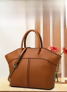 Macro detail of caramel brown leather tote with decorative stitching and fine texture