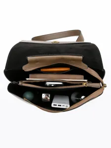 Spacious two-tone tote bag with gold lock showing internal compartments and daily essentials