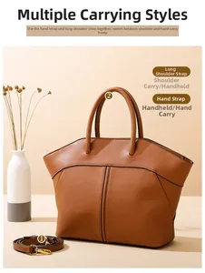 Detail of tan leather tote bag with sturdy handles and adjustable shoulder strap