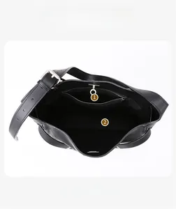 Top view showing the spacious interior compartment and zippered pocket of the black leather bag