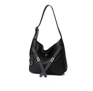 Detail view of the black hobo bag with silver turn-lock and soft leather pleats