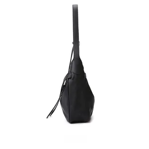 Side view of black minimalist shoulder bag with structured triangular silhouette