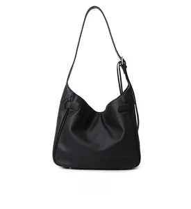 Detail view of the matte black tote bag showing side buckle and adjustable strap
