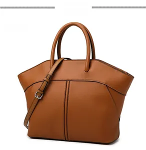 Detailed view of brown leather tote bag showing fine stitching and adjustable strap