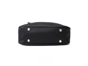 Detail of the black leather bag base featuring four silver metal feet for protection