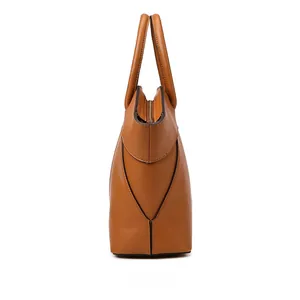 Side view of caramel brown tote bag with structured wing shape and gold zipper detail