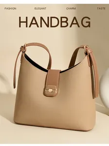 Detail view of the elegant leather bucket handbag featuring chic metal clasp and large capacity.