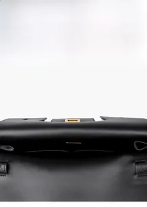 Top view of spacious black leather handbag interior with dual pockets and gold hardware