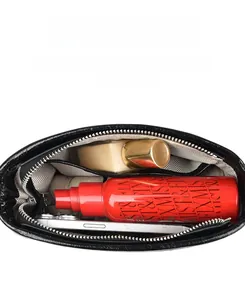 Interior view of black leather crossbody bag showing spacious storage with light lining