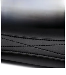 Detailed macro view of black leather stitching and high-quality craftsmanship of the bag