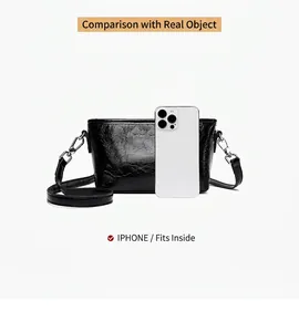 Detail view of black crackle texture crossbody bag showing internal space to fit a smartphone