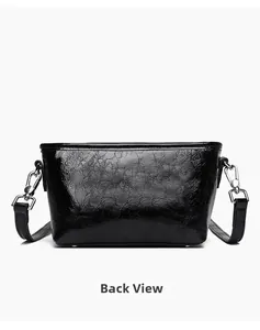 Detailed back view showing crinkled patent leather texture and metallic studs on black bag