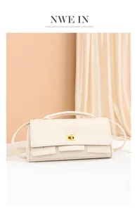 Detail of cream PU leather crossbody bag with golden twist lock and elegant handle