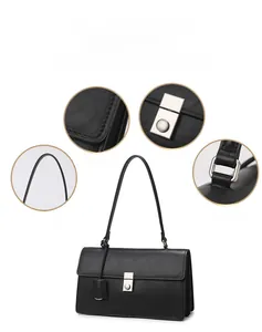 Detail view of black leather shoulder bag showing stitching and silver metal buckle lock
