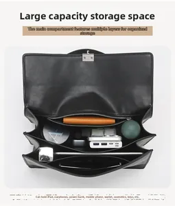 Internal view of black shoulder bag showing large capacity and multi-layer compartments