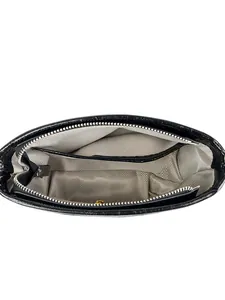 Top view of black cracked leather crossbody bag with spacious herringbone fabric interior
