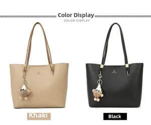 Detail view of khaki and black tote bags with lychee texture and plush charm