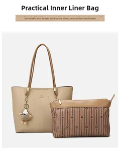Detail view of beige lychee tote with removable striped insert and plush charm detail