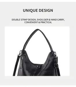 Detail of black pebbled leather hobo bag with adjustable dual straps and metal hardware