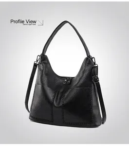 Side 45-degree angle view showing 3D silhouette of black pebbled leather hobo tote bag