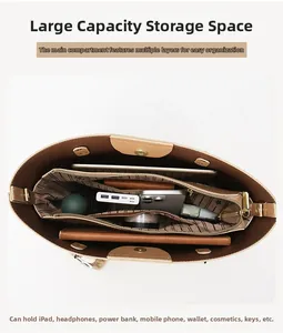 Detailed interior of the brown leather tote showing spacious multi-layer storage compartments