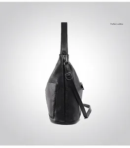 Detail view of the black leather tote bag showing side profile and stitching craftsmanship